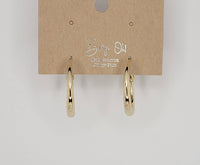 Gold hoop earrings on a Betty Oh! branded card against a light gray background
