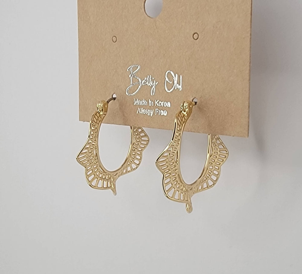 Gold earrings on a brown card with 'Bella Oh' branding against a gray background