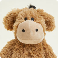 Brown plush donkey toy on a light beige background