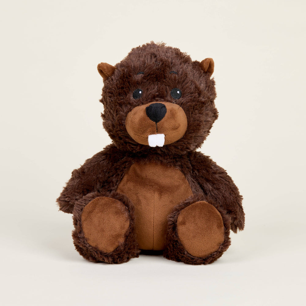 Stuffed animal toy resembling a beaver on a beige background