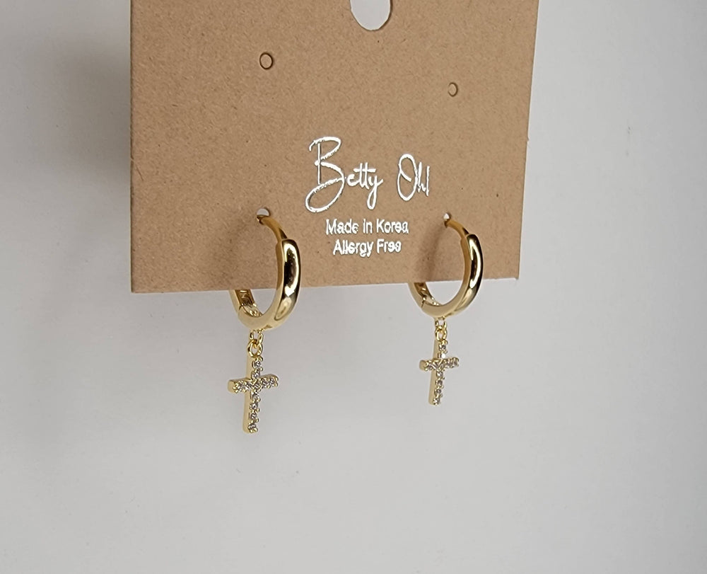 Gold hoop earrings with cross charms on a 'Betty Oh!' branded card.