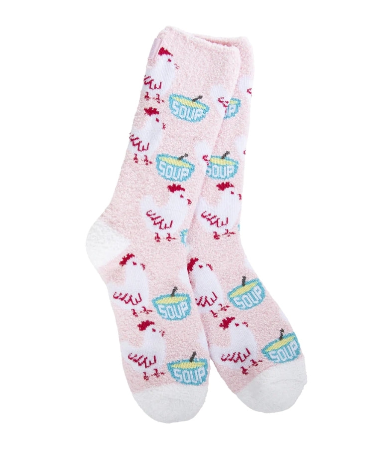 light pink socks with multiple white chickens with red outline and blue bowls with yellow soup inside and a spoon handle sticking out. The bowls have the word soup written on them